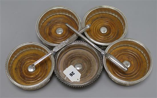 A set of four plated wine coasters, a similar coaster and two marrow scoops